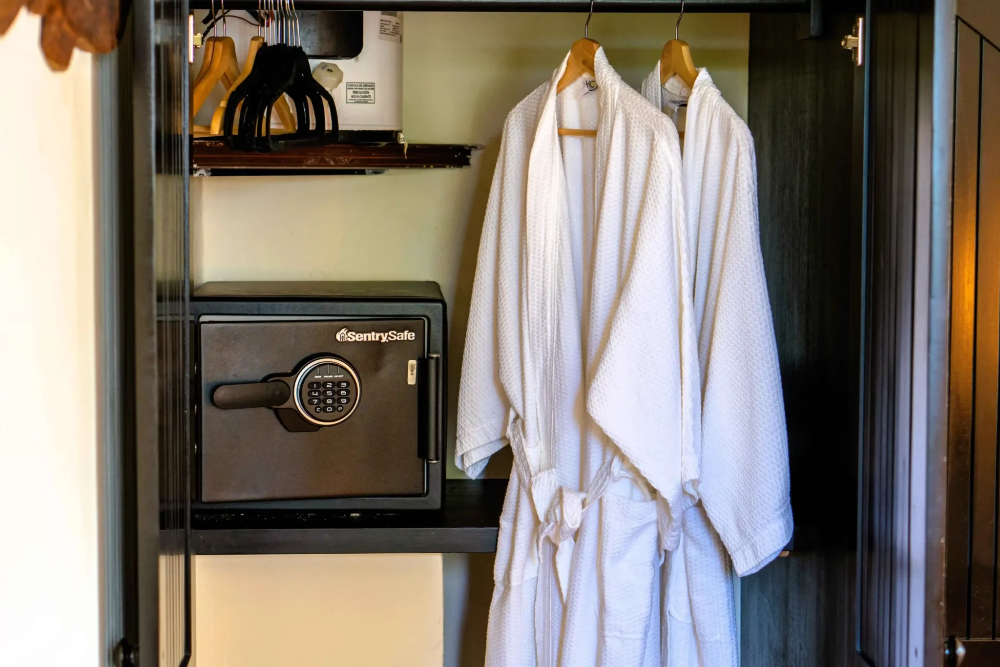 Plush robes and in-room safe in a Casa de Jardín suite
