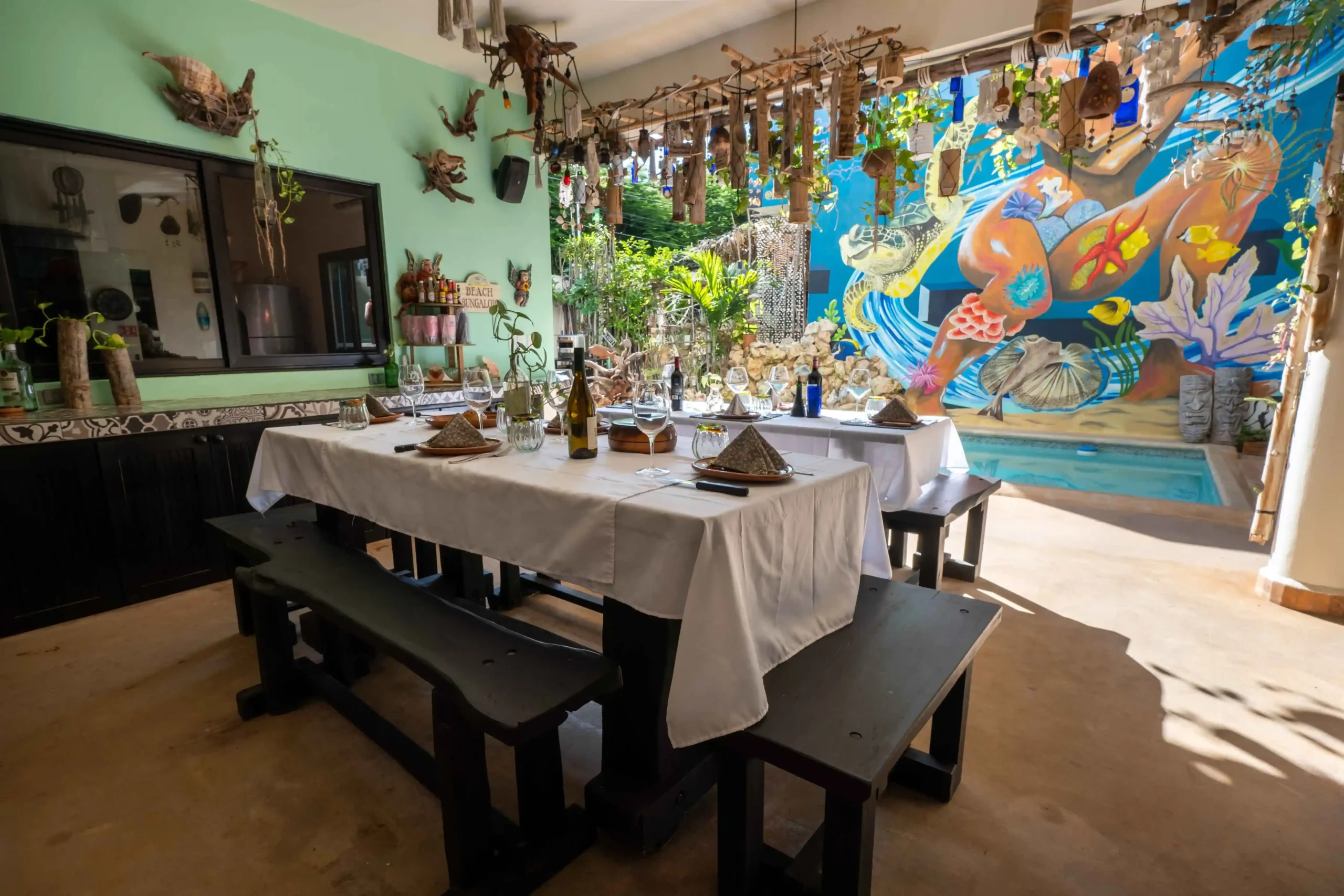 Casa de Jardín kitchen wall with hanging mugs and warm details